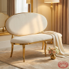 White oval sofa hotel suite wedding lounge 45 degree plush velvet warm golden light