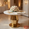 White marble round table at hotel wedding signing table florals pen guest book faceted column