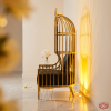 Gold birdcage throne side view wedding VIP zone arch shadow radiating golden glow marble