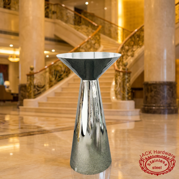 Silver funnel cocktail table at grand luxury hotel lobby marble staircase golden lighting