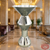 Silver diamond geometric cocktail table at luxury 5-star hotel grand lobby marble columns chandelier
