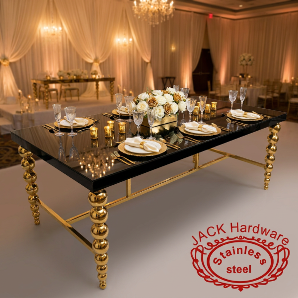 Gold ball-column leg table at hotel wedding banquet gold charger plates crystal flutes reflections