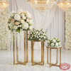 Gold 3-piece round pedestal stands at wedding floral display white peonies roses chandeliers