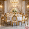 Gold round disc-back chairs at grand wedding banquet hall round dinner table chandeliers