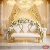 White gold heart loveseat at grand wedding venue sweetheart seat white florals crystal chandeliers