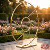 Gold compass moon gate at outdoor hotel garden terrace golden hour lush greenery marble terrace