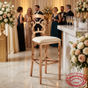 Rose gold baroque bar stool at upscale hotel champagne reception guests floral background
