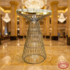 Gold wire cage hourglass cocktail table at grand luxury hotel lobby golden marble chandelier