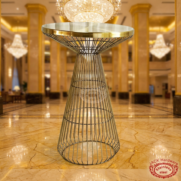 Gold wire cage hourglass cocktail table at grand luxury hotel lobby golden marble chandelier