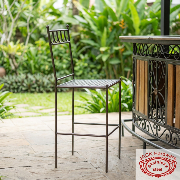 Dark iron art bar stool at boutique hotel garden terrace bar lush greenery natural light