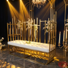 Gold tube fence bench hotel wedding stage 45 degree sculptural bars varying height golden glow