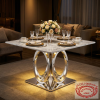 Silver sculptural ring column base dining table at hotel VIP event space gold charger plates 45 degree