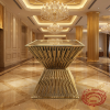 Gold radial tube square bar table at grand luxury hotel lobby marble gold columns chandelier