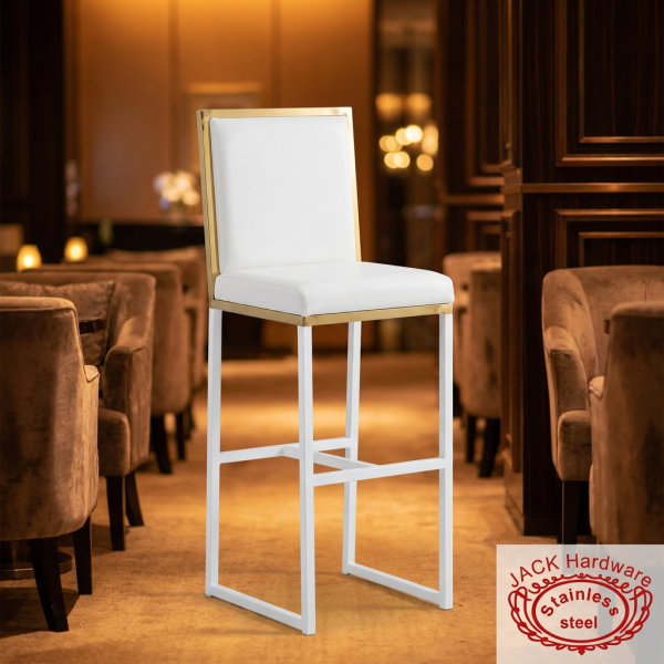 White gold bar stool at modern hotel cocktail lounge warm amber ambient lighting