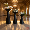 Matte black hourglass 3 stands side view ballroom cascading staircase warm rim lighting marble