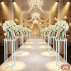 Multiple white ring stands as hotel banquet aisle decorations with floral arrangements