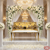Gold perforated loveseat bench at wedding reception sweetheart seat florals chandeliers marble