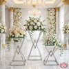 Silver geometric X-cross frame 3-piece stands at wedding floral display roses chandeliers