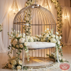 Silver birdcage swing at wedding venue bridal photo spot white florals 45 degree warm spotlights