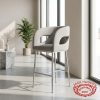 Modern grey half-barrel bar stool at boutique hotel lobby cafe bright natural window light minimalist