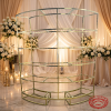 Gold semi-circular wine rack at luxury wedding banquet hall with white roses