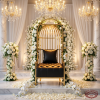 Gold birdcage throne chair at grand wedding venue dramatic focal point chandeliers marble