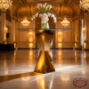 Gold X-twist hourglass sculptural stand side view ballroom uplighting bold silhouette marble