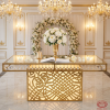 Gold rose-carved signing table at wedding entrance guest sign-in florals chandeliers crystals