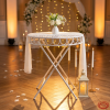 White iron garden table side view wedding venue candlelight vintage shadow X-cross legs romantic