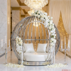 Silver spherical birdcage sofa at luxury hotel lobby wedding bridal zone chandeliers white florals