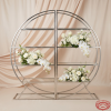 Circular wine shelf with champagne drape background and white flower arrangement