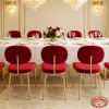 Red velvet floating backrest chairs at modern luxury hotel restaurant wedding dinner table chandeliers
