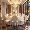 Gold round drum dining chairs at modern luxury hotel restaurant dinner table chandeliers