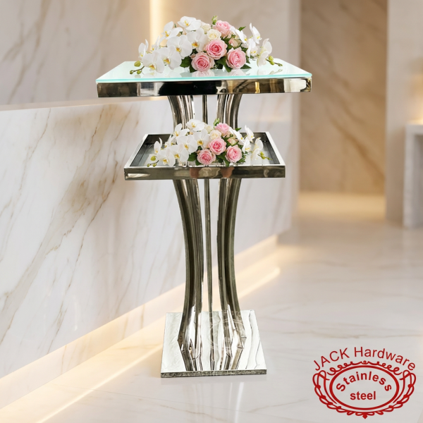 Silver two-tier service stand at hotel spa suite entrance white orchids roses soft lighting