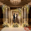 Gold LED crystal pillar set as wedding ceremony backdrop glowing columns floral arrangements chandeliers
