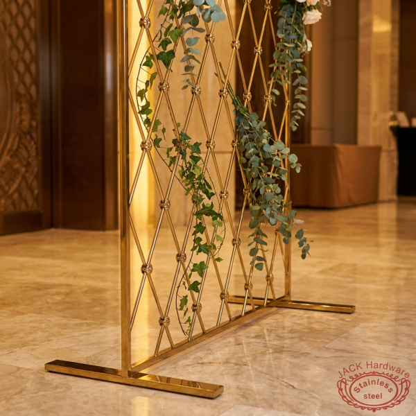 Gold diamond grid backdrop as hotel event space decorative partition greenery eucalyptus marble floors