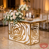 White gold rose vine carved table at hotel wedding reception rose pattern panel warm spotlights