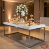 Silver dessert table at hotel event space dessert display orchid rose centerpiece warm spotlights