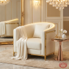 Ivory barrel armchair hotel suite wedding reception 45 degree gold frame warm golden light