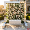 Silver square frame swing at luxury hotel garden terrace floral wall white cushion seat