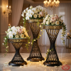 Black spiral twisted column Greek key rim stands hotel wedding 45 degree helix detail warm spotlights