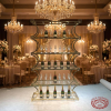 Gold 6-tier wave column rack at grand luxury wedding reception champagne bottles crystal glasses chandeliers