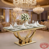 Gold horn-leg glass dining table at luxury hotel banquet hall fine china crystal glasses floral chandelier