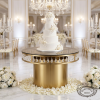 Matte gold round crystal pendant cake table at wedding with 5-tier wedding cake roses chandeliers