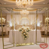 Gold screen set behind sweetheart table hotel wedding reception candelabras florals crystal chandelier