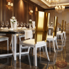 Gold mirror backrest dining chair hotel restaurant 45 degree gold panel white legs warm spotlights